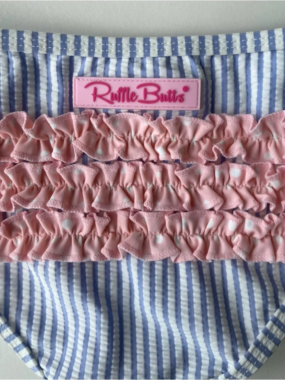 RuffleButts Blue Seersucker Two-Piece Swimsuit with Pink Polka Dot Ruffles